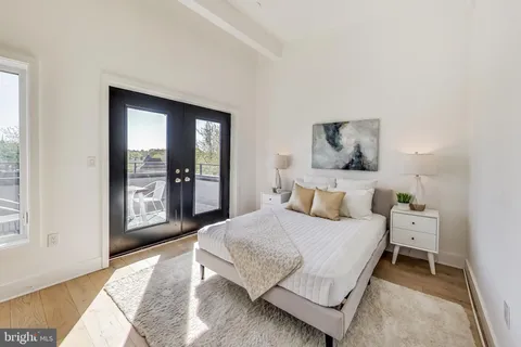 a bedroom with a bed and large window