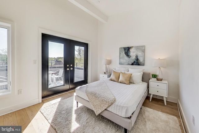 a bedroom with a bed and large window