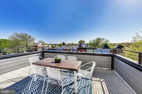a view of roof deck with furniture