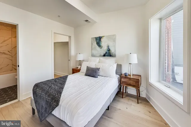 a bedroom with a bed and a window