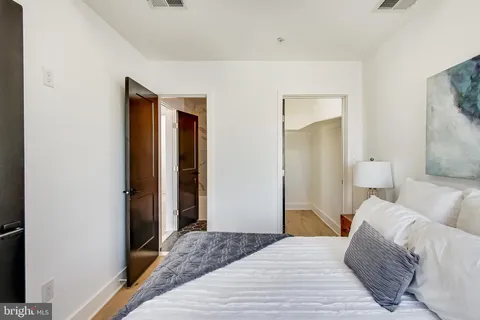 a bedroom with a bed and a mirror