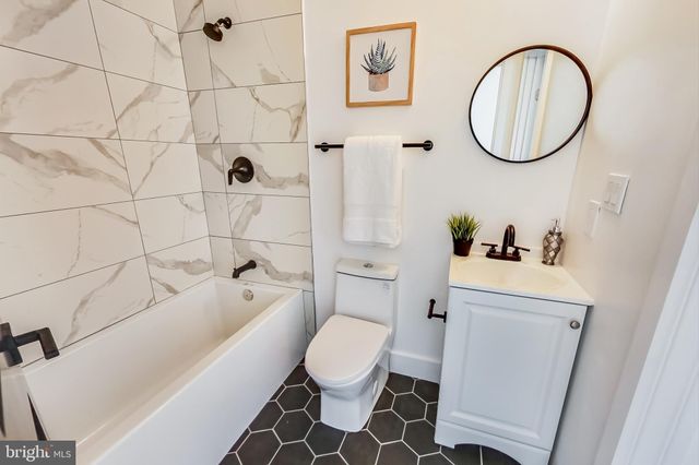 a white toilet sitting next to a bathroom sink