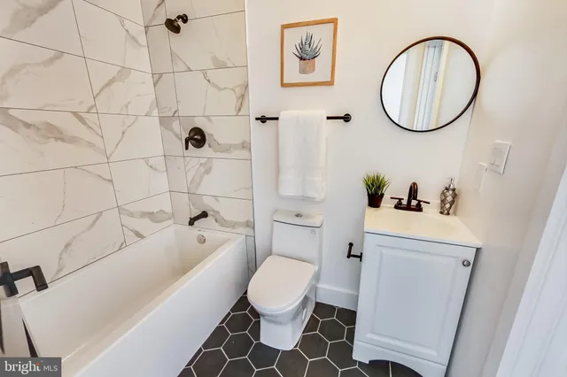 a white toilet sitting next to a bathroom sink