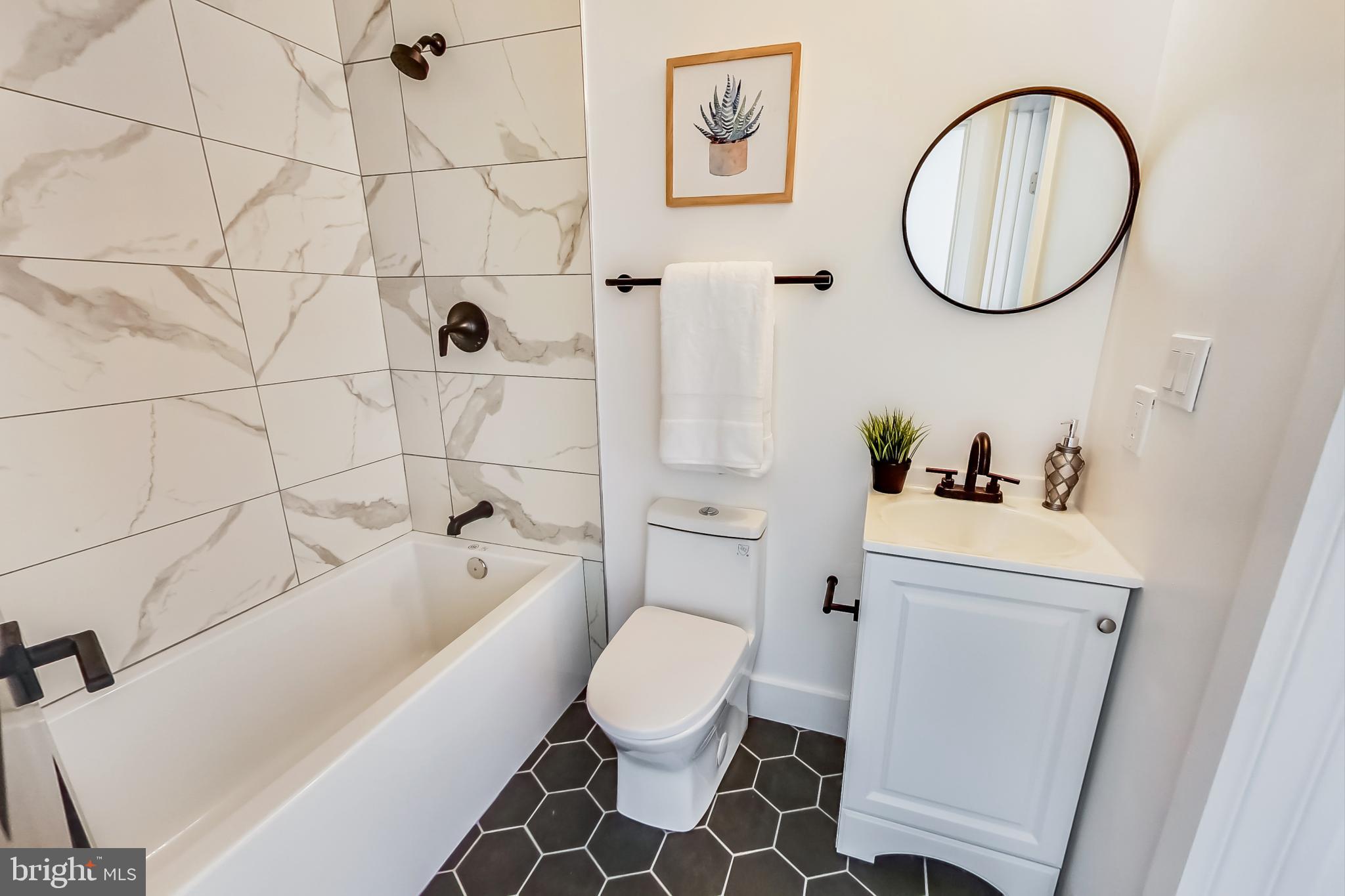 207 Florida Avenue Northwest, Unit 3 Washington, DC 20001 - Photo 28 of 34 a white toilet sitting next to a bathroom sink