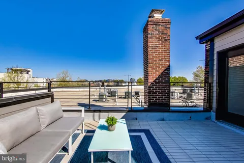 a view of a balcony with dining table