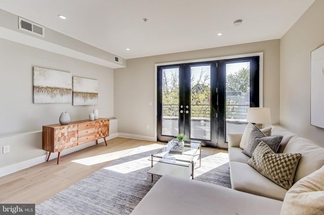 a living room with furniture and large windows