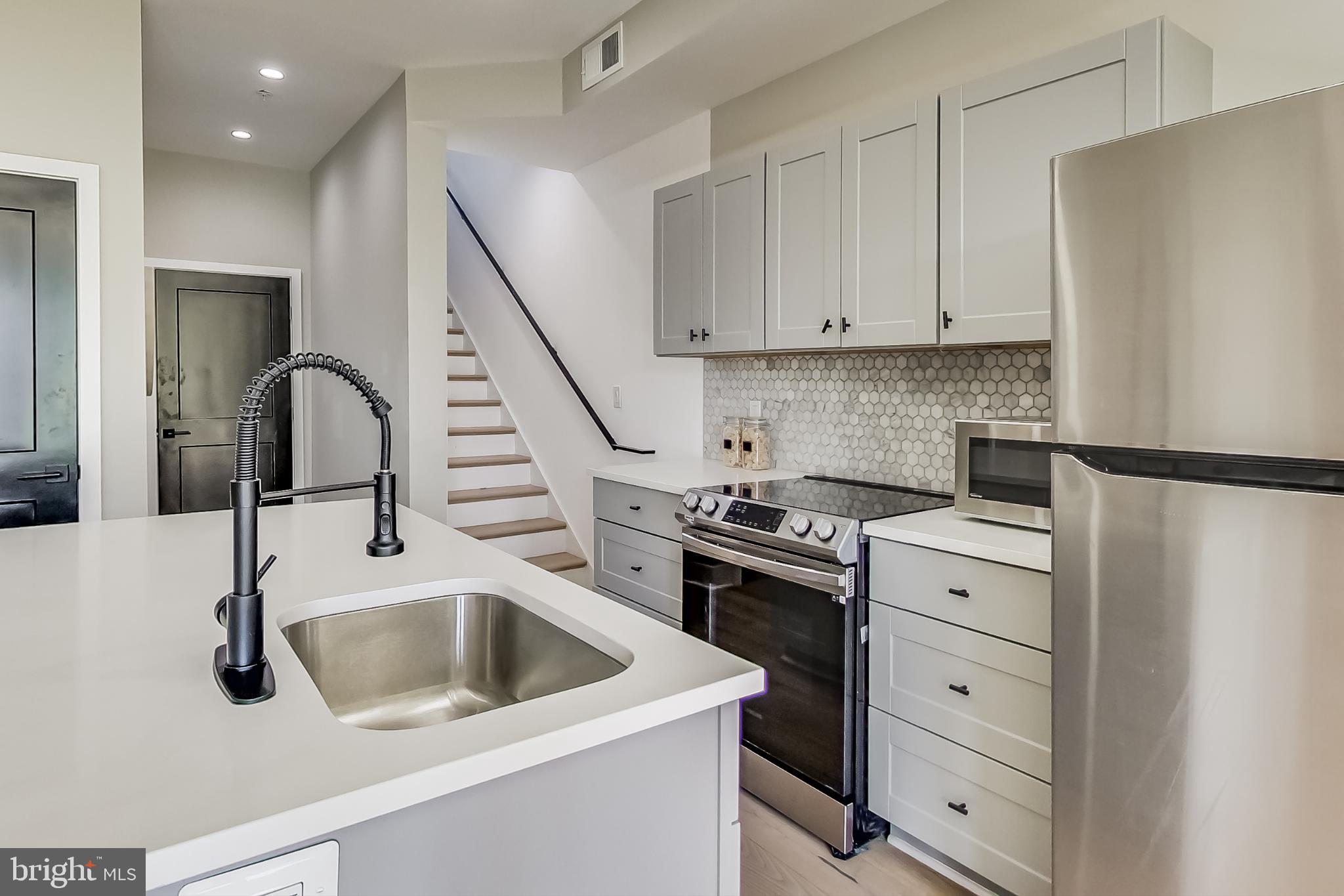 207 Florida Avenue Northwest, Unit 3 Washington, DC 20001 - Photo 9 of 34 a kitchen with white cabinets and appliances