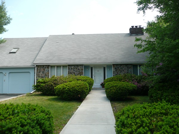 11 Barrett Road Lexington, MA 02421 - Photo 1 of 14 a front view of a house with a garden