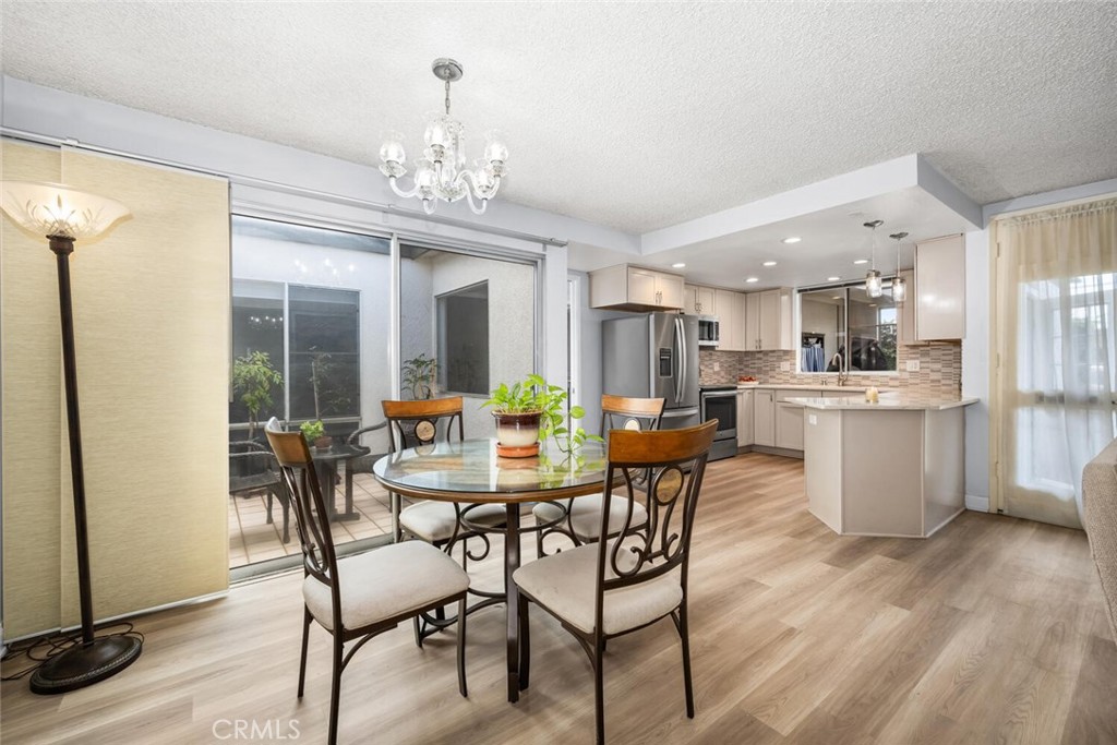 13120 Del Monte Drive, Unit 47G Seal Beach, CA 90740 - Photo 11 of 42 a view of a dining room with furniture and a chandelier