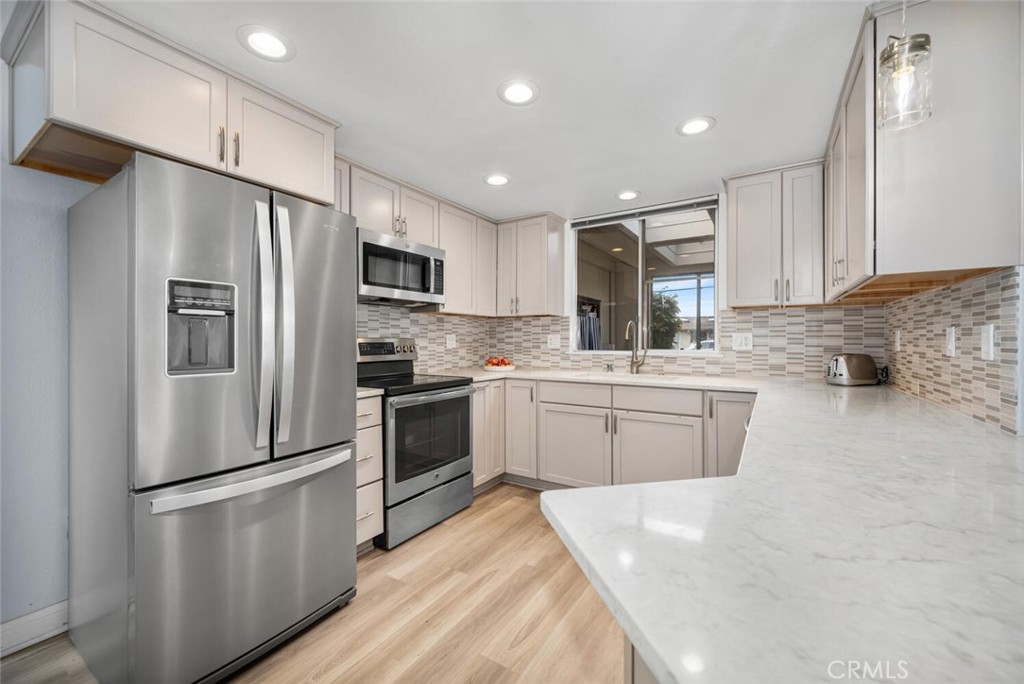 13120 Del Monte Drive, Unit 47G Seal Beach, CA 90740 - Photo 15 of 42 a kitchen with a refrigerator a sink and cabinets