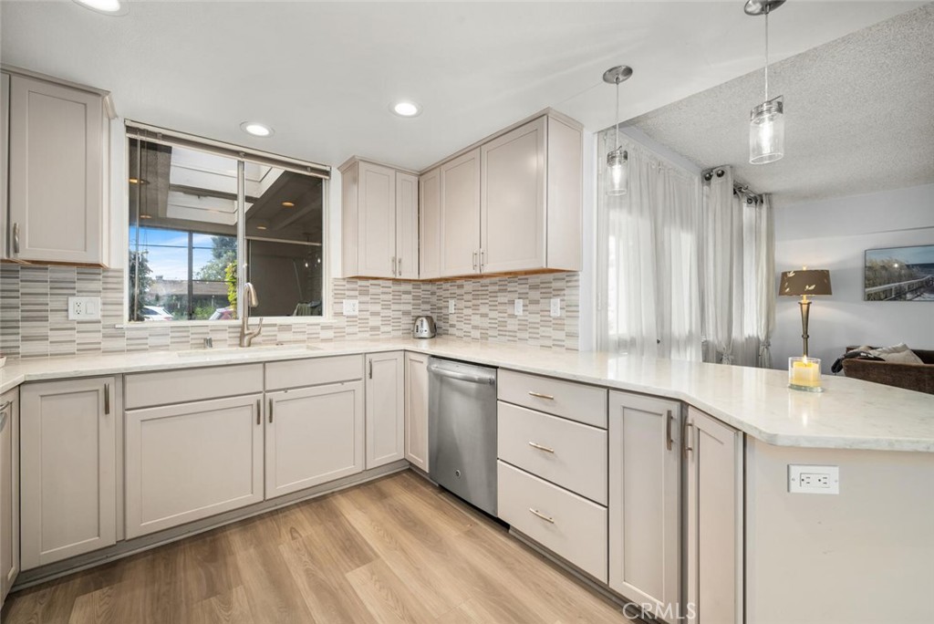 13120 Del Monte Drive, Unit 47G Seal Beach, CA 90740 - Photo 20 of 42 a kitchen with a sink stove and cabinets