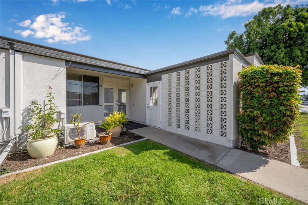 13120 Del Monte Drive, Unit 47G Seal Beach, CA 90740 - Photo 2 of 42 a view of a porch with a chairs and plants