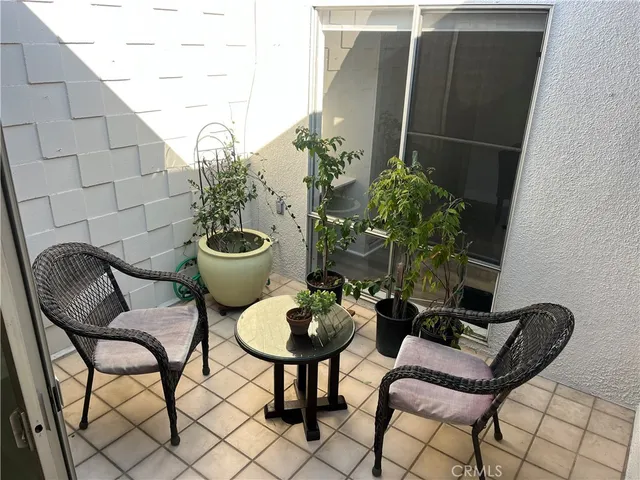 a table and chairs in a potted flower pot