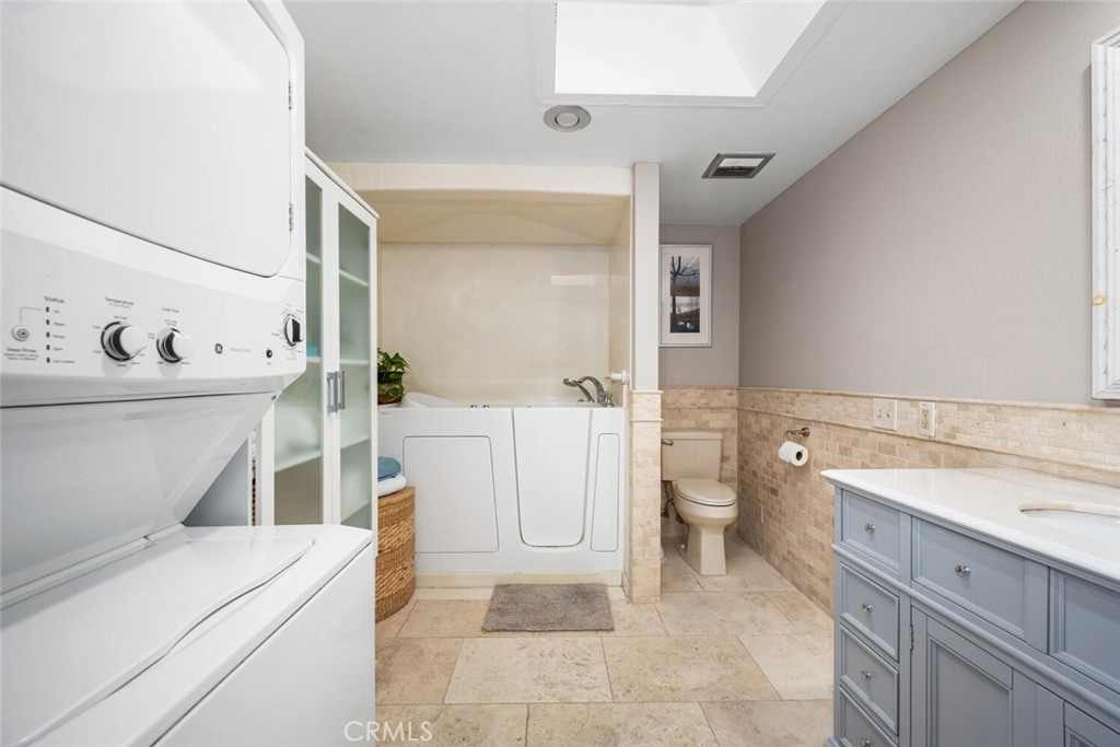 13120 Del Monte Drive, Unit 47G Seal Beach, CA 90740 - Photo 27 of 42 a bathroom with a sink a toilet and a mirror