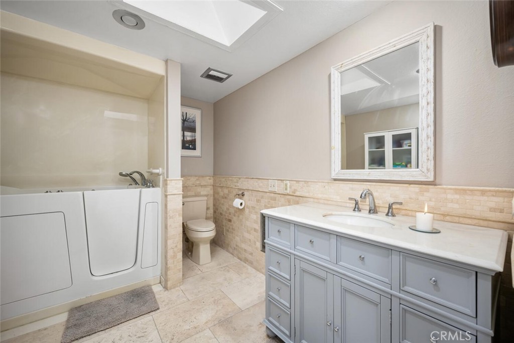 13120 Del Monte Drive, Unit 47G Seal Beach, CA 90740 - Photo 28 of 42 a bathroom with a double vanity sink mirror and toilet