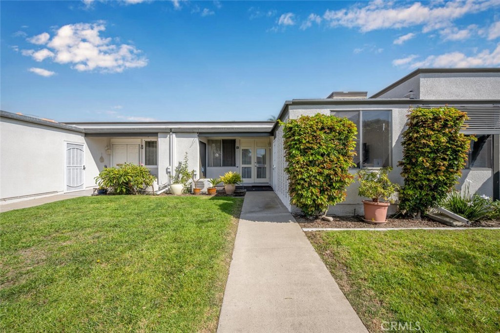 13120 Del Monte Drive, Unit 47G Seal Beach, CA 90740 - Photo 3 of 42 a front view of a house with garden