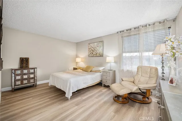 a bedroom with bed and wooden floor