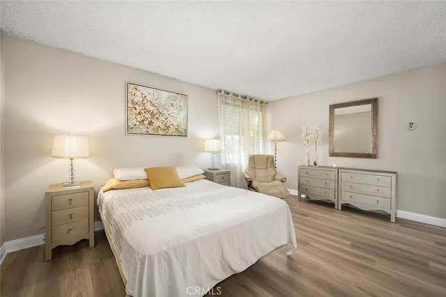 a bedroom with a bed and a lamp