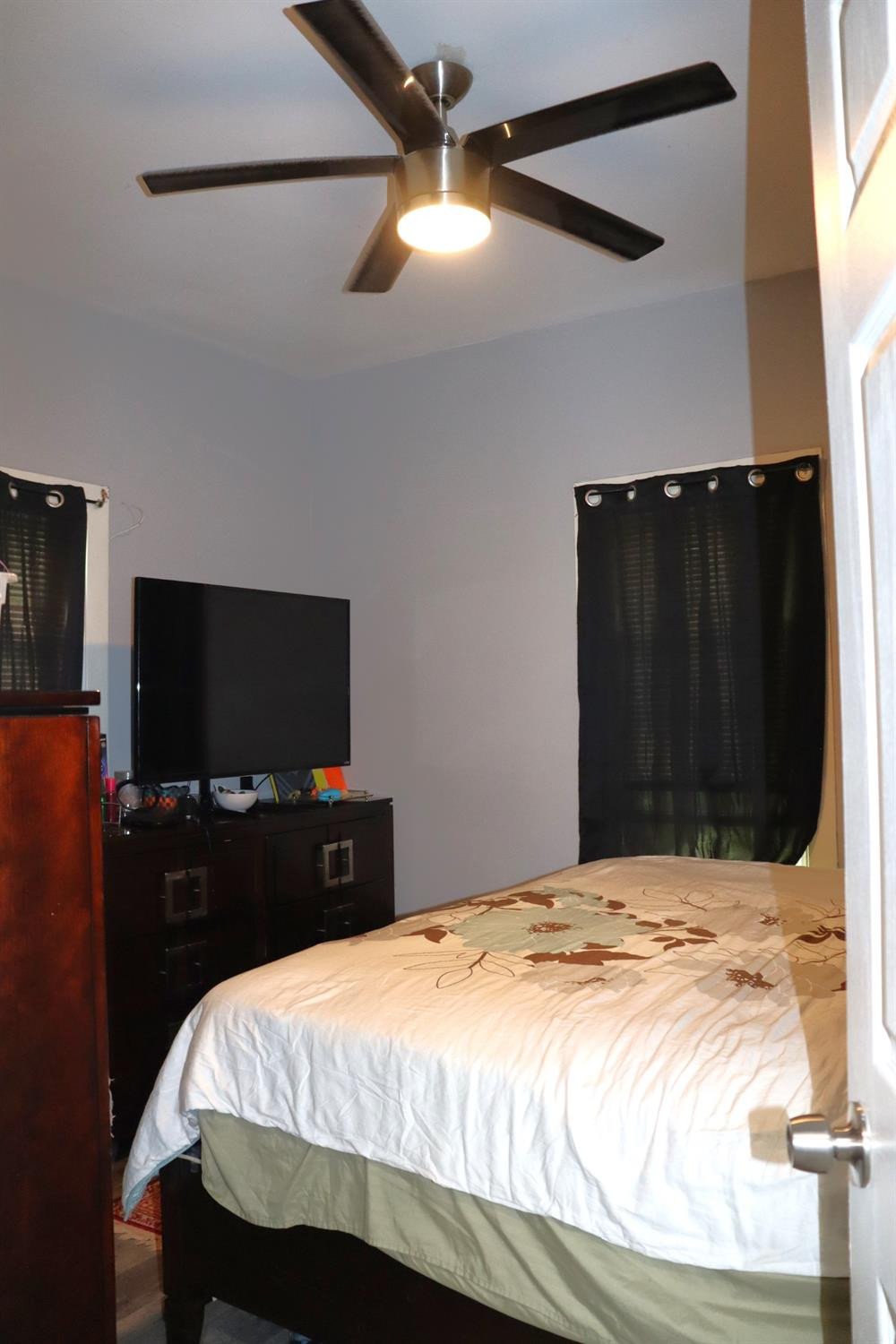 528 Mount Street Gary, IN 46406 - Photo 15 of 29 a bedroom with a bed and a flat tv screen on dresser
