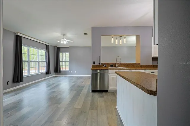 a kitchen with granite countertop a stove and a sink