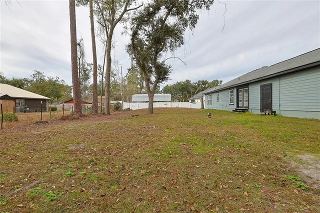 a front view of house with yard and trees