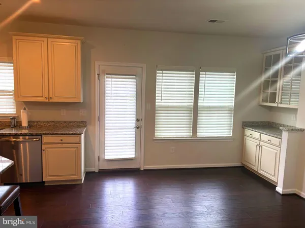 a view of a kitchen with a sink dishwasher and a fireplace