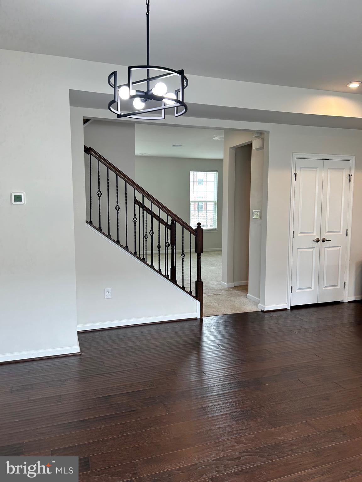 642 Barrie Road Middletown, DE 19709 - Photo 23 of 36 a view of a hallway with wooden floor and staircase