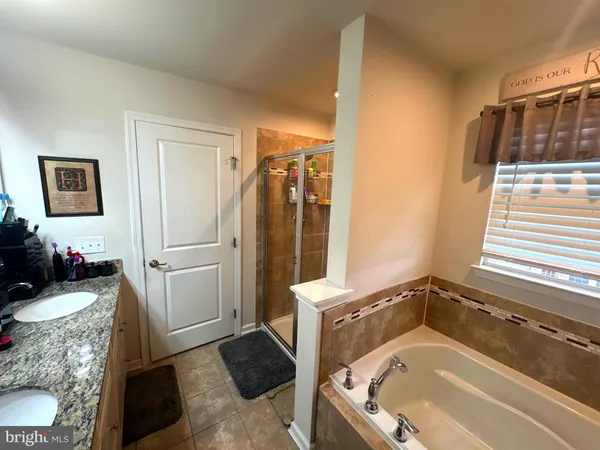 a bathroom with a tub and a shower