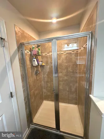 a bathroom with a glass shower door