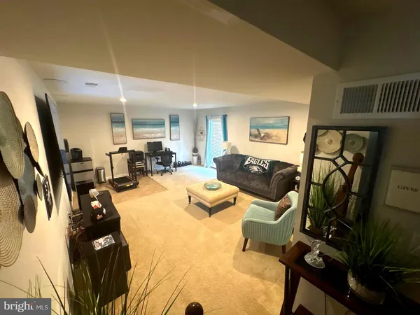 a living room with furniture hard wood floor and a fireplace