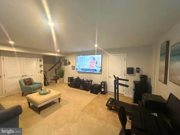 a livingroom with workspace couch and a window