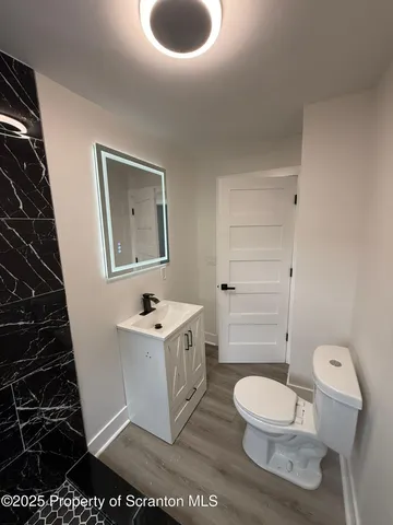 a bathroom with a toilet a sink and a shower