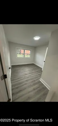 a bedroom with a bed and a night stand