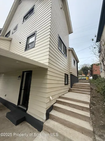 a view of a white house with a large windows