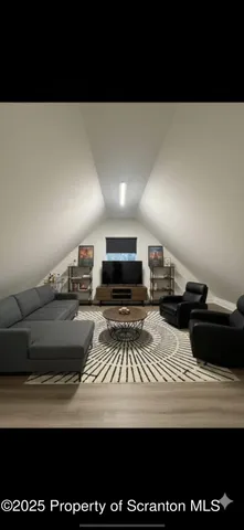 a view of a room with wooden floor