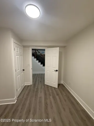 an empty room with wooden floor