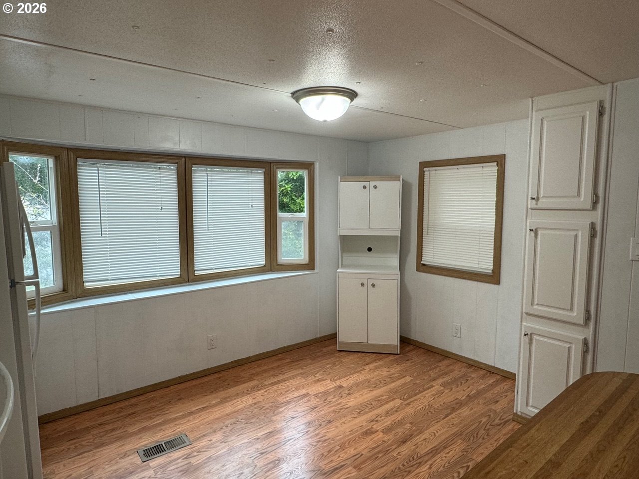 1600 Rhododendron Drive, Unit 293 Florence, OR 97439 - Photo 15 of 26 an empty room with windows and cabinet