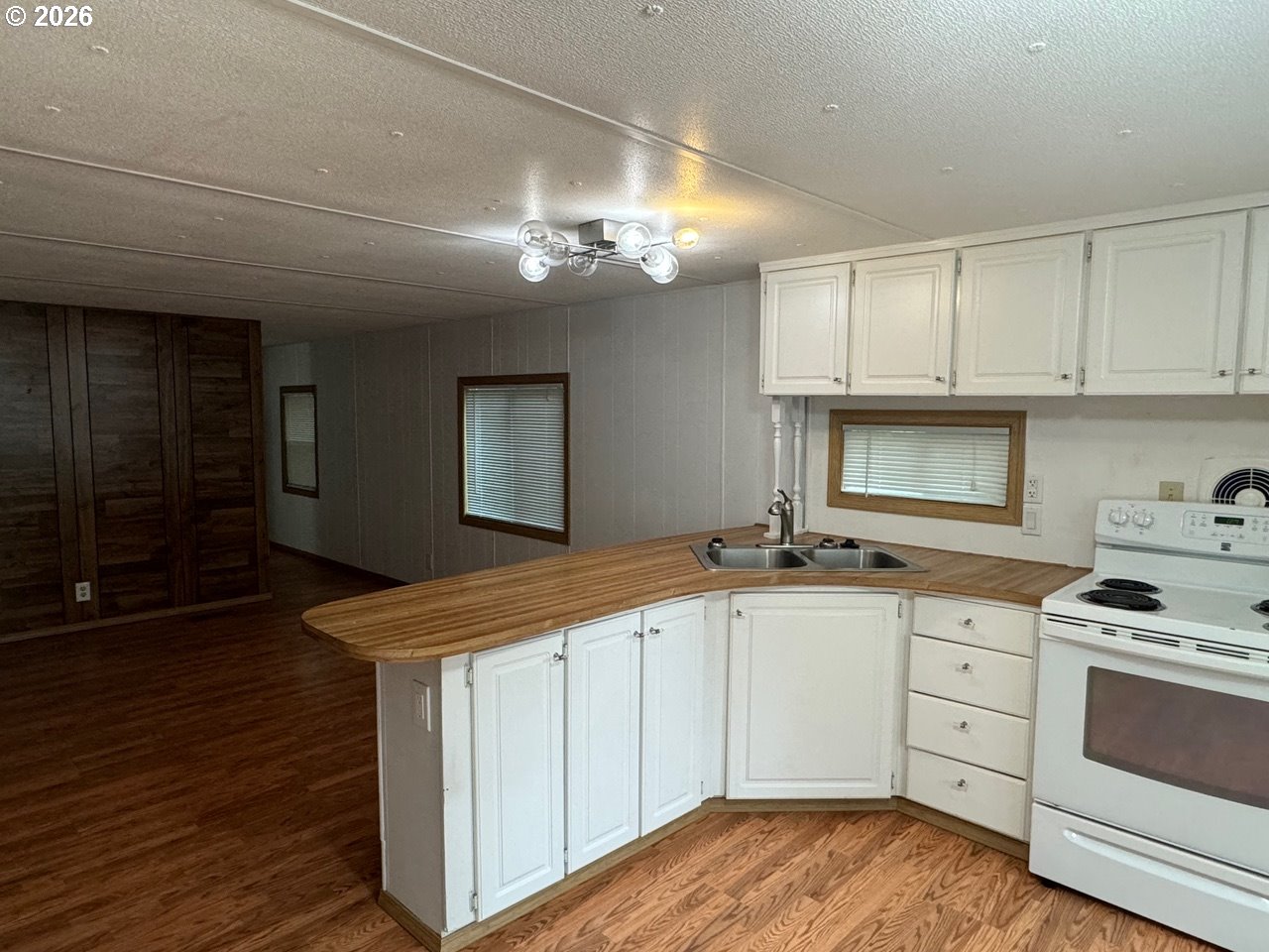 1600 Rhododendron Drive, Unit 293 Florence, OR 97439 - Photo 17 of 26 a kitchen with granite countertop a sink and cabinets