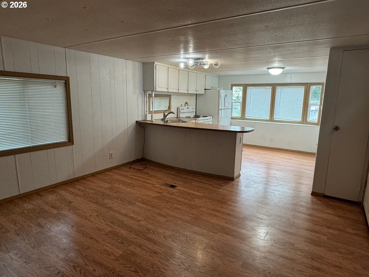 1600 Rhododendron Drive, Unit 293 Florence, OR 97439 - Photo 18 of 26 a kitchen with kitchen island stainless steel appliances counter space and wooden floor