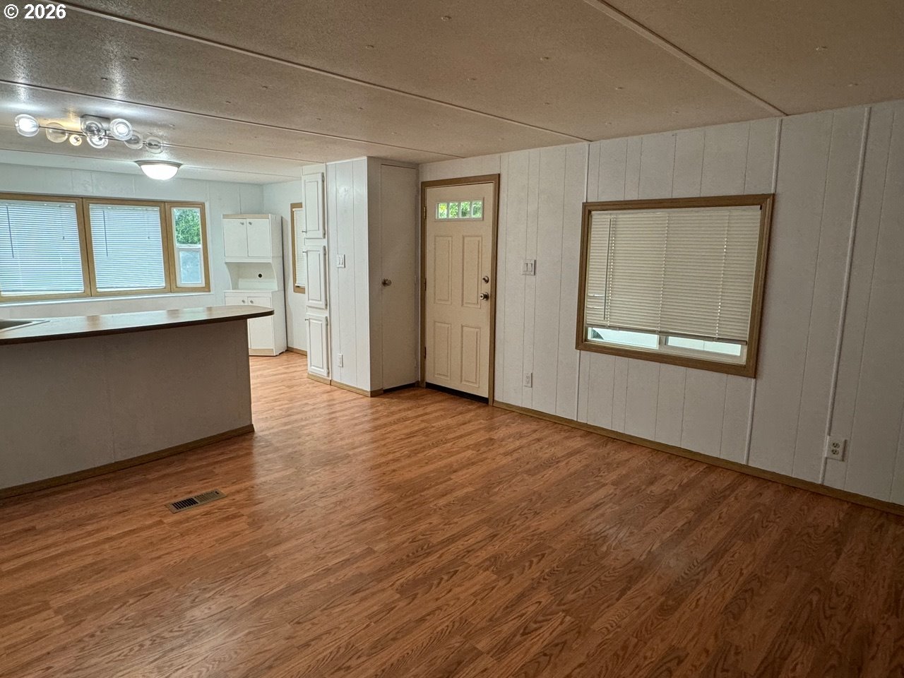 1600 Rhododendron Drive, Unit 293 Florence, OR 97439 - Photo 19 of 26 a view of an empty room with wooden floor and a window