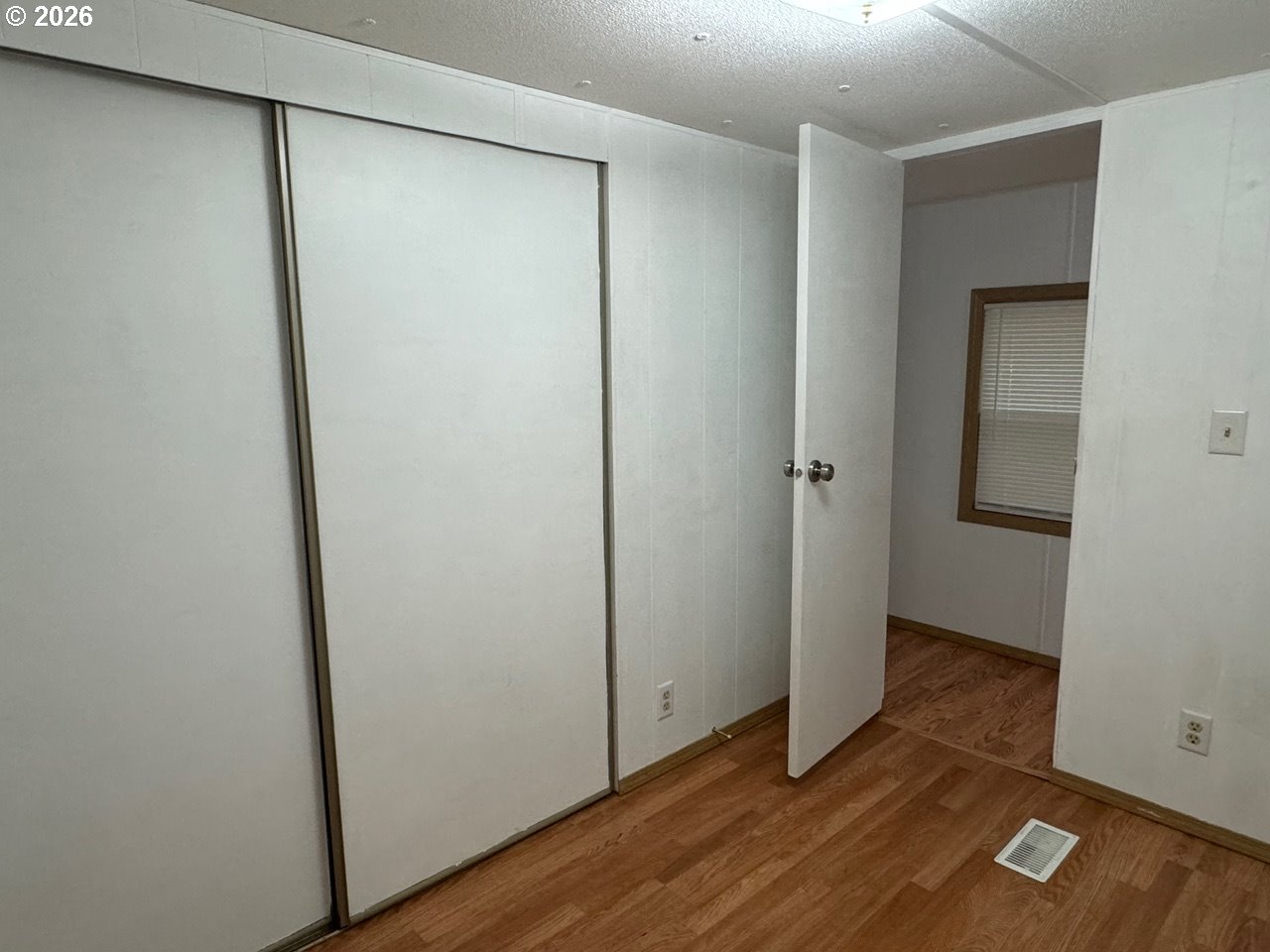 1600 Rhododendron Drive, Unit 293 Florence, OR 97439 - Photo 21 of 26 an empty room with wooden floor and closet