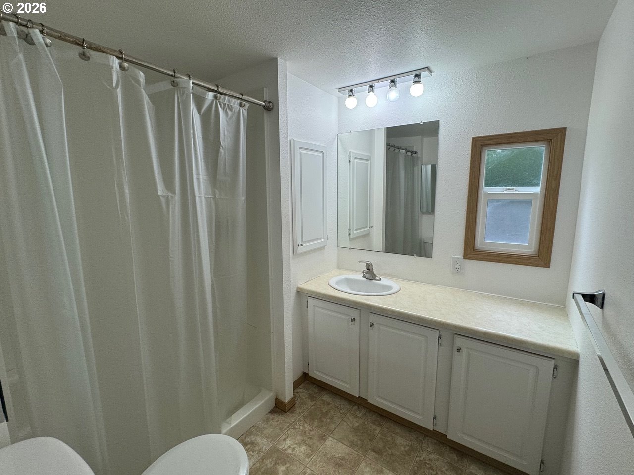 1600 Rhododendron Drive, Unit 293 Florence, OR 97439 - Photo 23 of 26 a bathroom with a double vanity sink and mirror