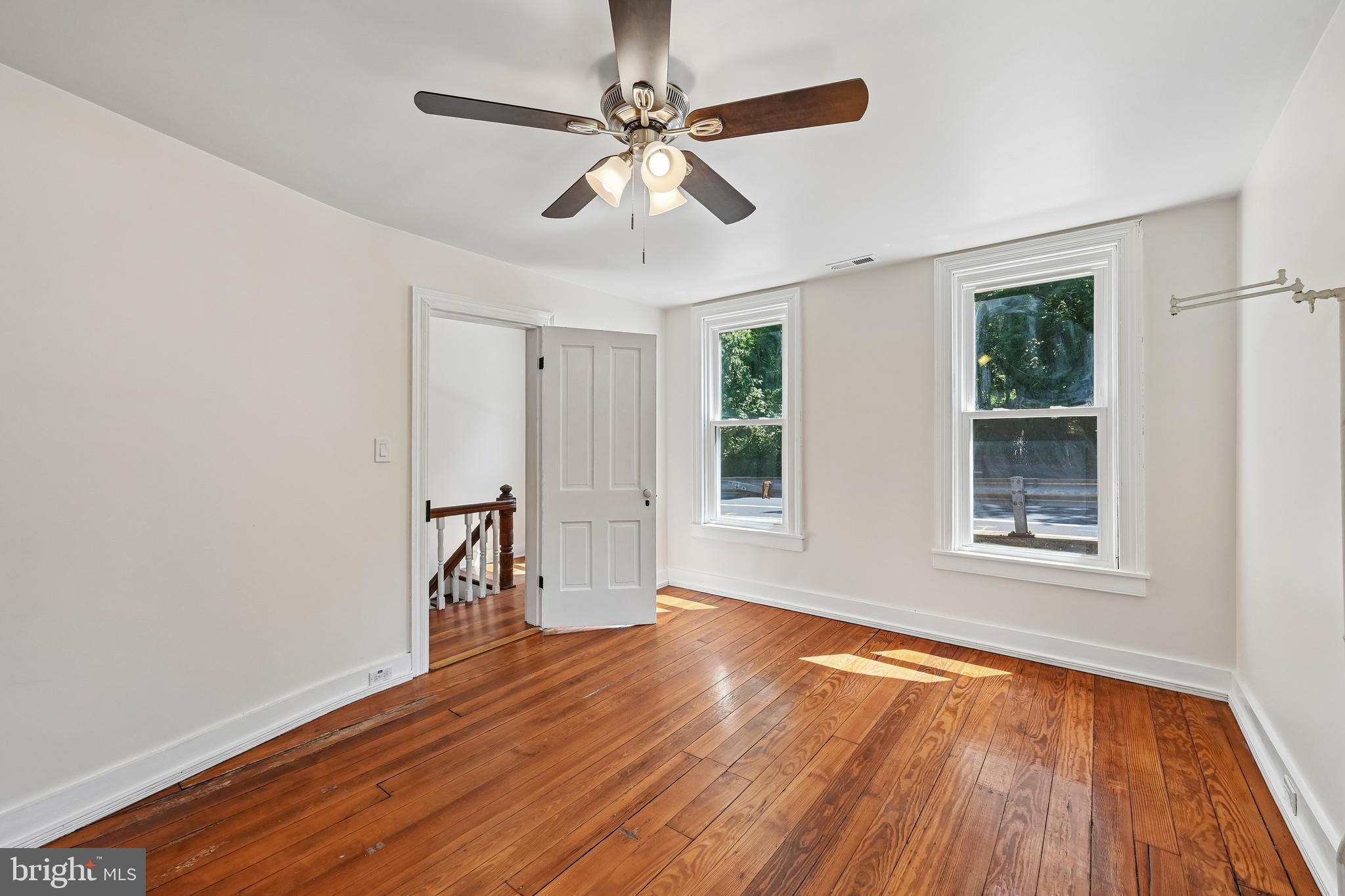 5702 Falls Road Baltimore, MD 21209 - Photo 25 of 49 a view of an empty room with wooden floor and a window