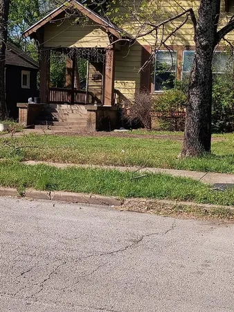 a view of a house with a yard and sitting area