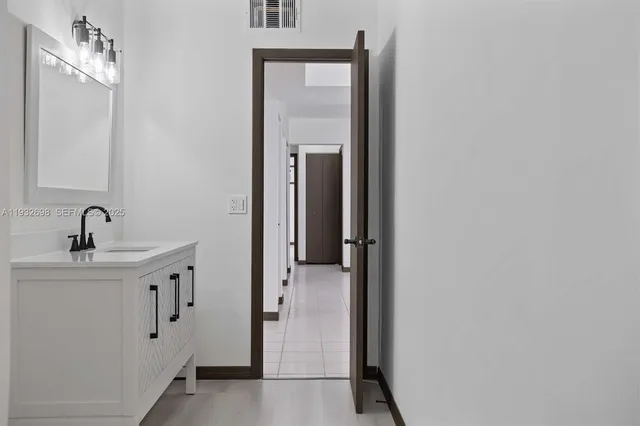 a bathroom with a sink and mirror