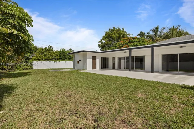 a view of house with a backyard