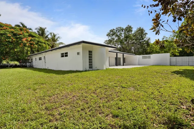 a view of a backyard with large trees