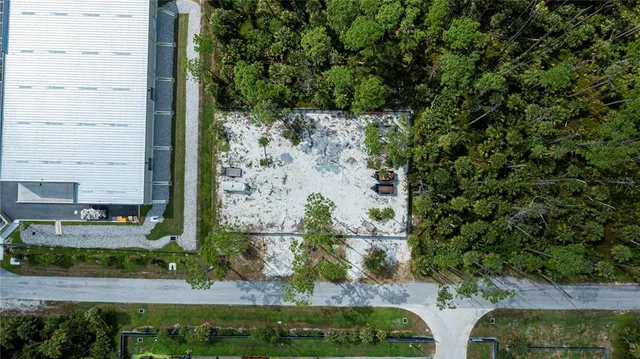 an aerial view of residential house with outdoor space and trees
