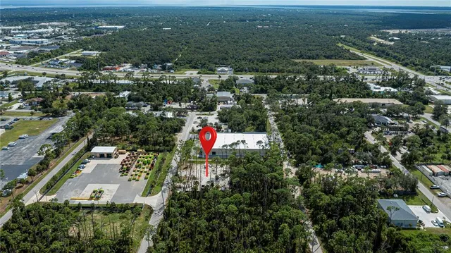 an aerial view of residential house with outdoor space and swimming pool