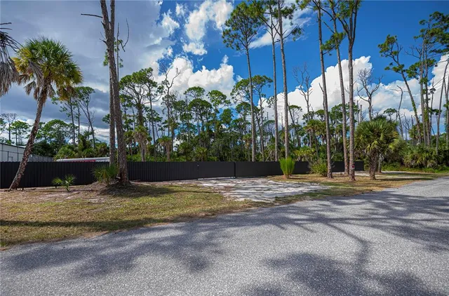 a view of a house with a yard and a street